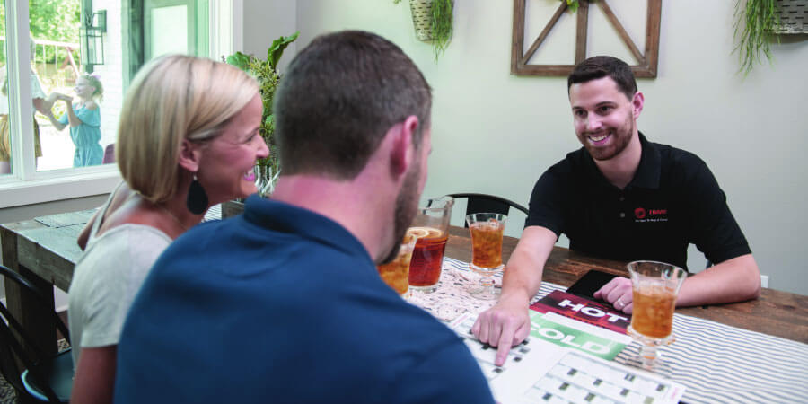 Service technician speaking with homeowners about maintenance plans