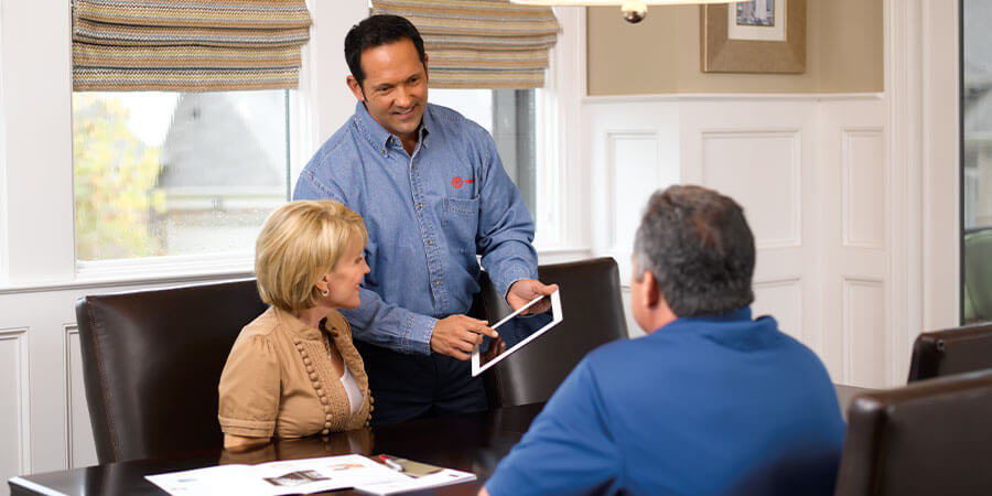 Service technician explaining stuff to couple